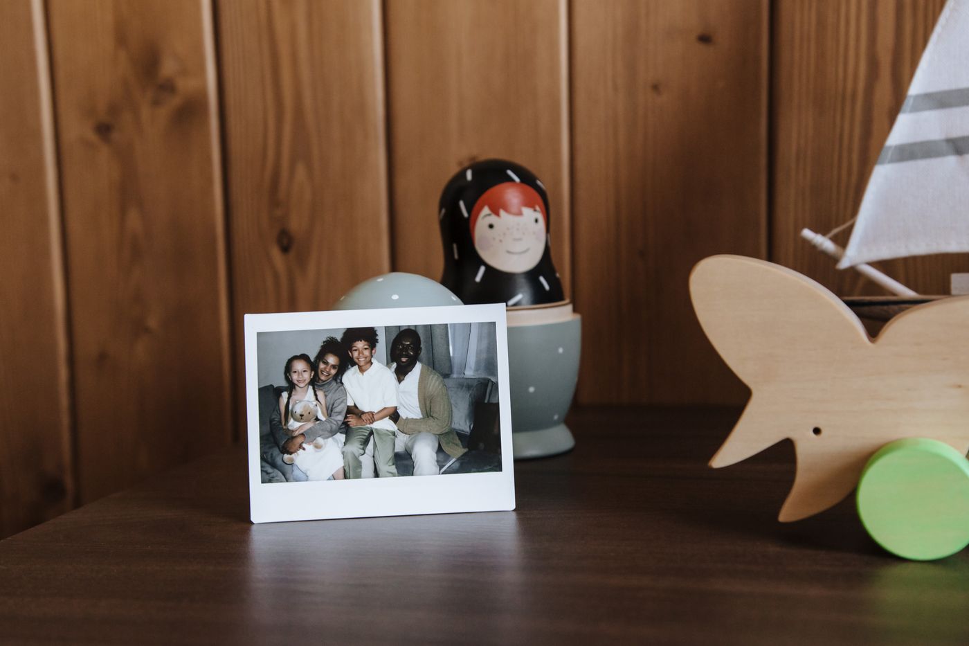 A framed family photograph on a dresser