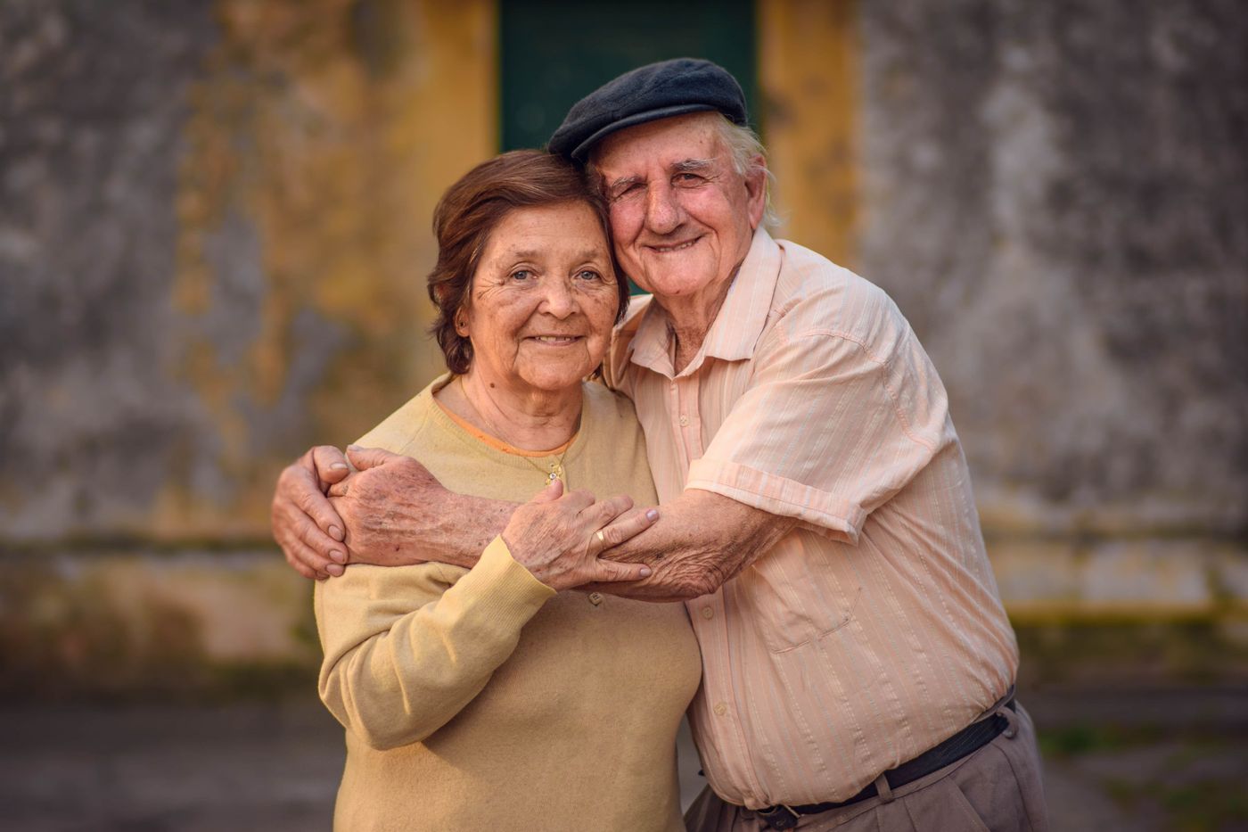 A senior couple embracing outdoors