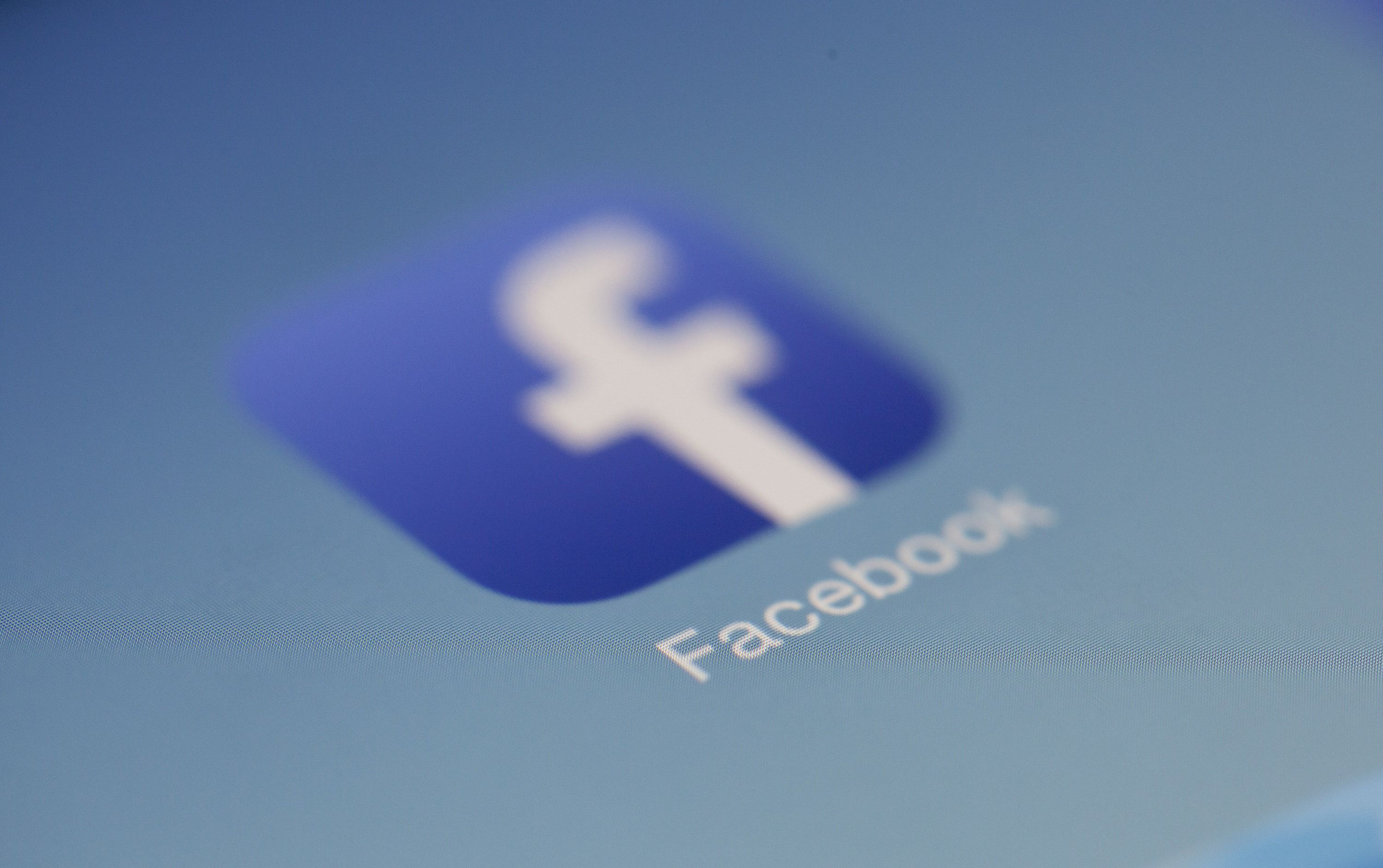 A blurred Facebook app icon on a phone screen